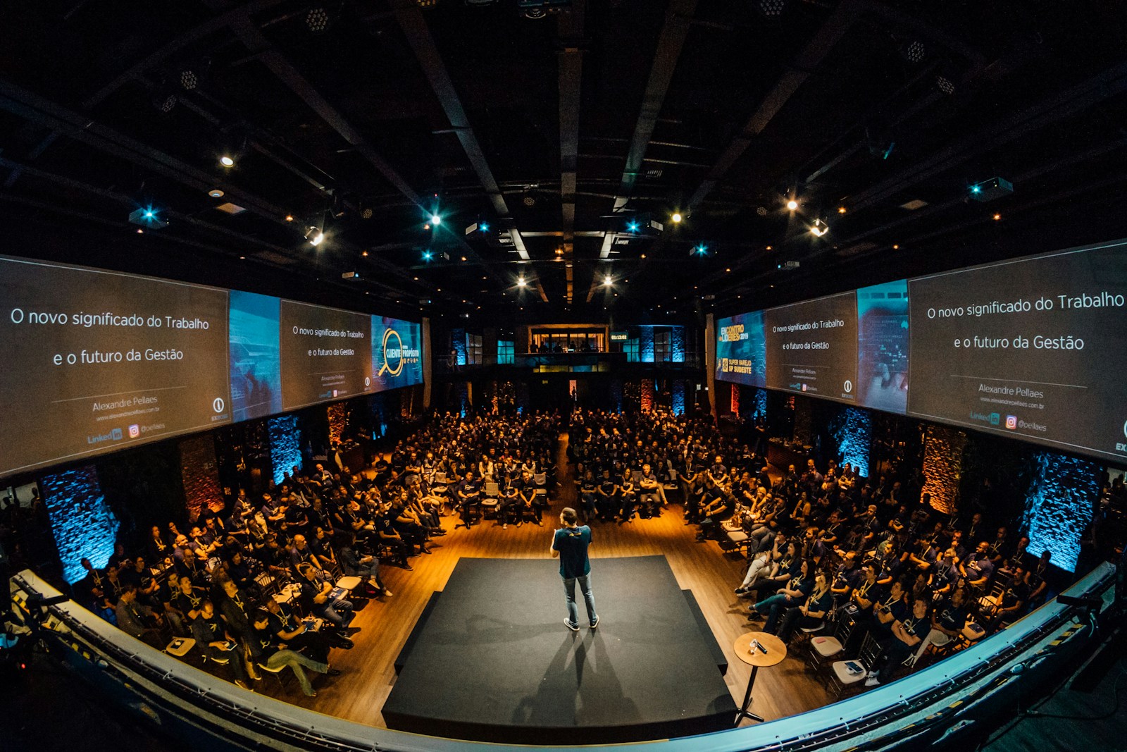 Speaker on stage addressing an audience of marketing leaders